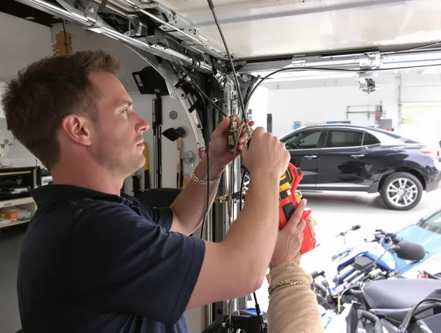 Green Garage Door Repair safety certified technician performing cable replacement in Green