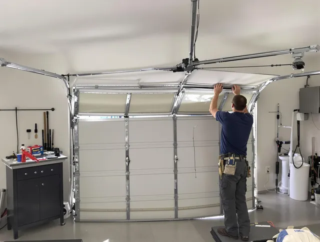 Green Garage Door Repair specialist performing precise section replacement on Green garage door