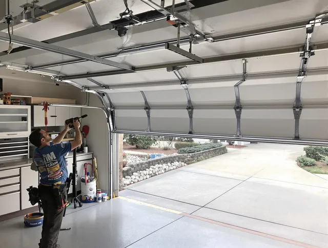 Garage door track repair service by Green Garage Door Repair in Green